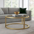 Table basse ronde avec plateau en verre trempé et cadre en acier finition laiton