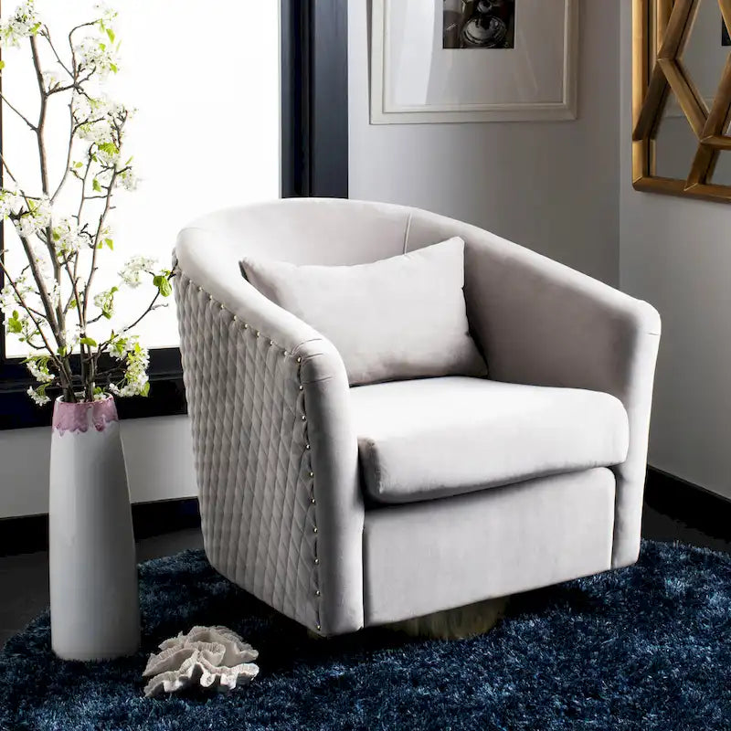 Fauteuil pivotant en velours bleu marine matelassé losanges avec garniture cloutée
