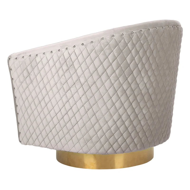 Fauteuil pivotant en velours bleu marine matelassé losanges avec garniture cloutée
