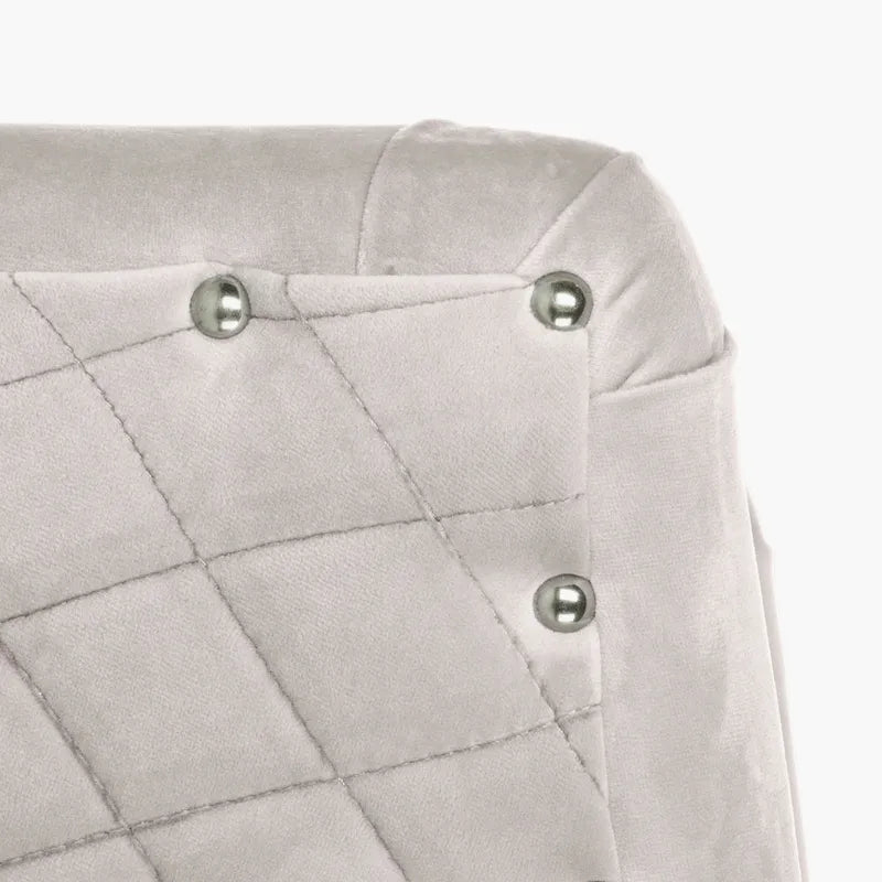 Fauteuil pivotant en velours bleu marine matelassé losanges avec garniture cloutée
